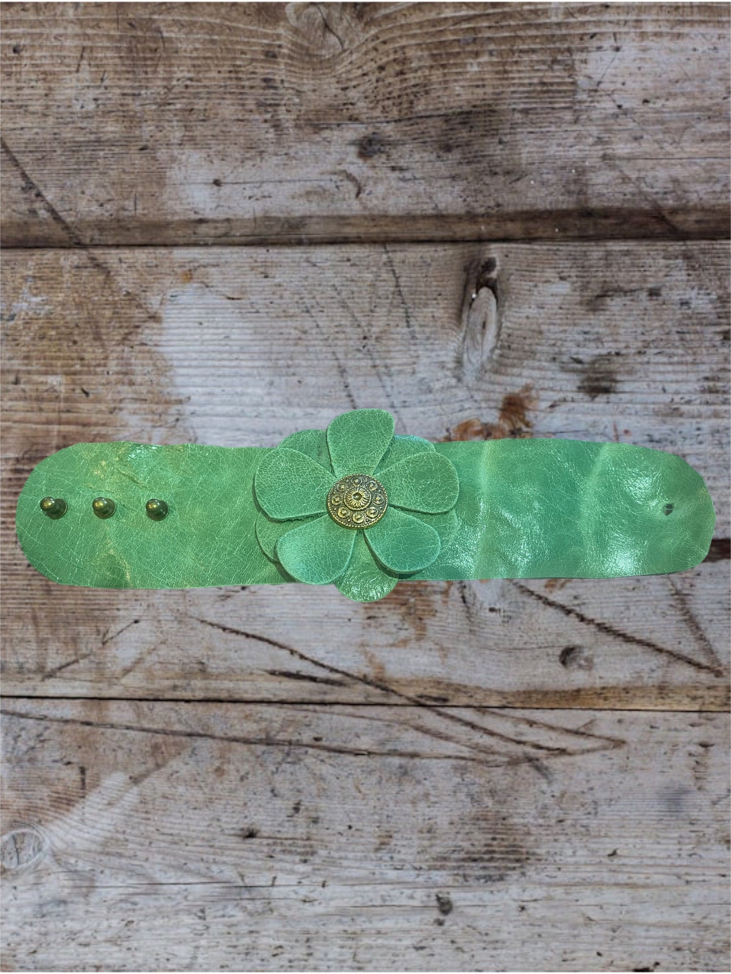 Green Leather Flower Cuff Bracelet with Gold Button Detail.